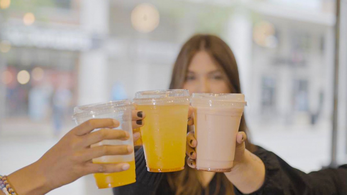 Guests holding drinks at an event
