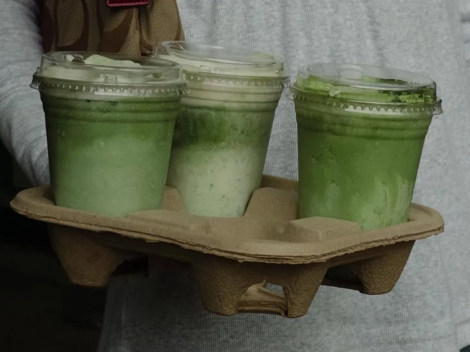 Three iced matcha drinks to go in a cup carrier
