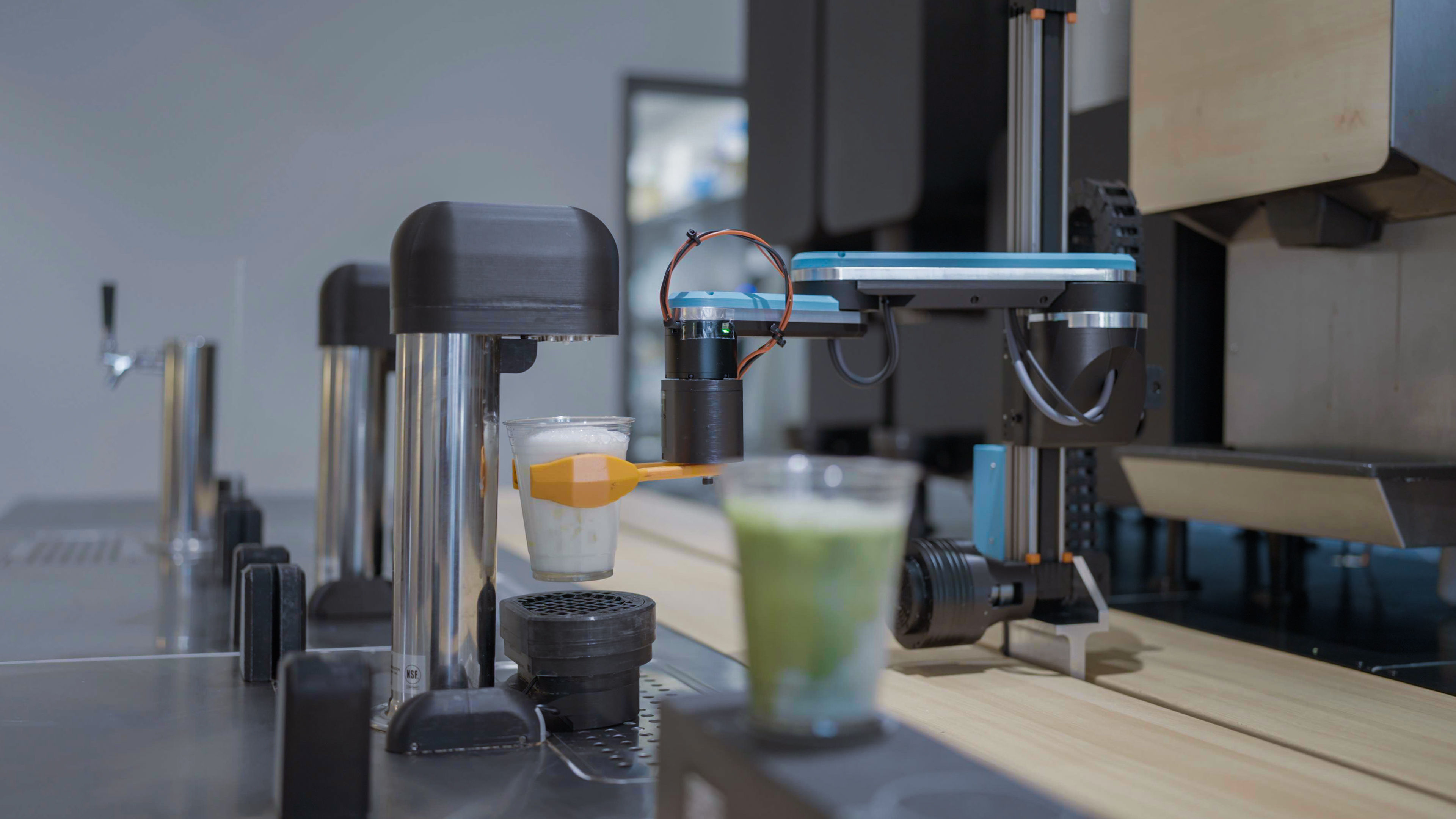 Side view of an early-generation Yummy Future robotic unit — the machine running the first store