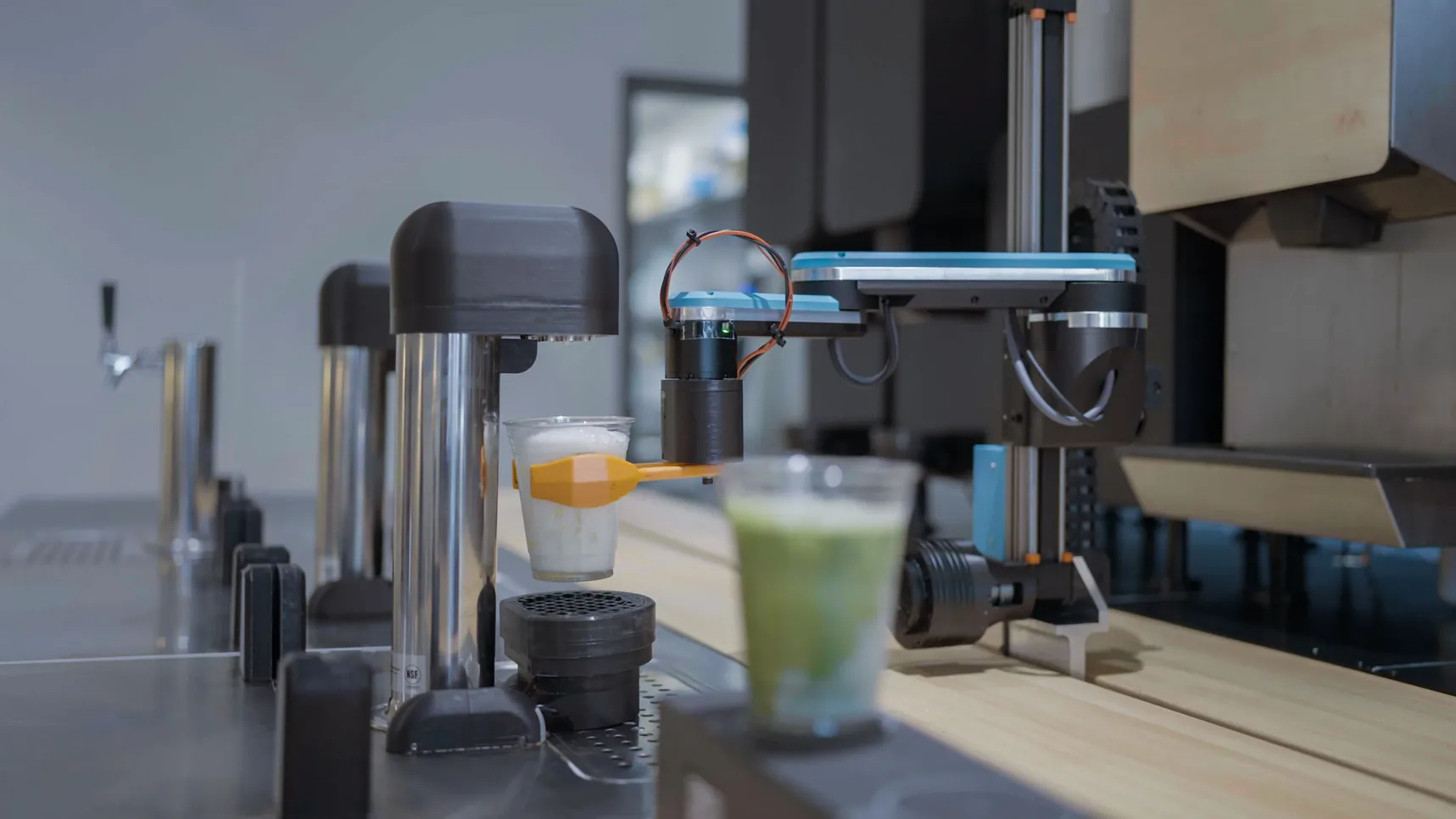 Side view of an early-generation Yummy Future robotic unit, the machine running the first store