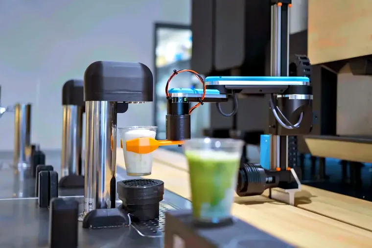 Side view of an early-generation Yummy Future robotic unit, the machine that ran the first store