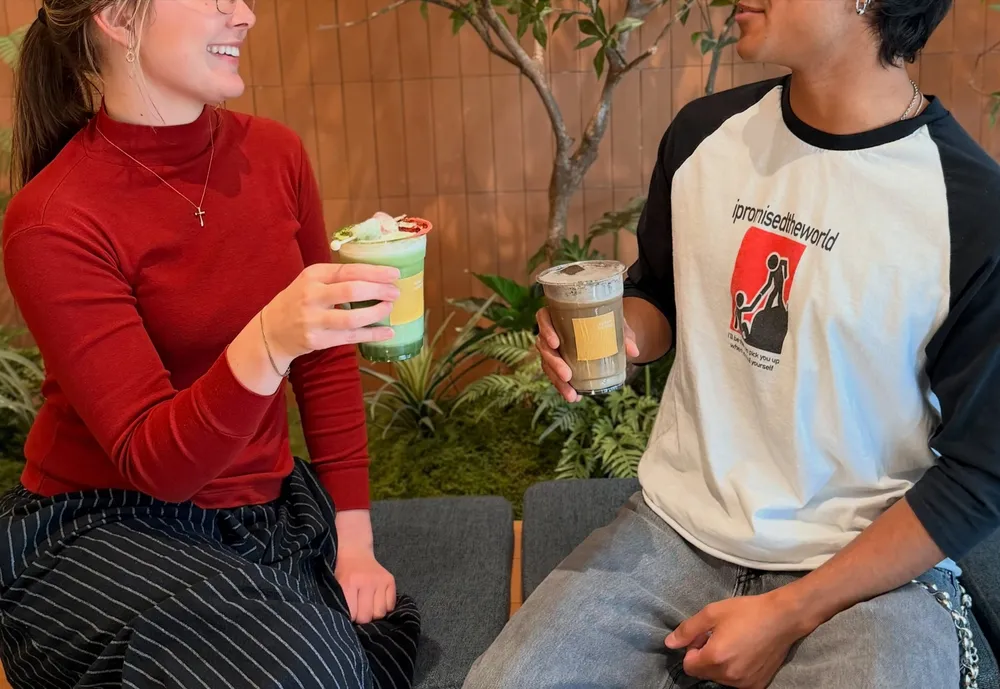 Two guests toasting with their drinks in our Palo Alto store