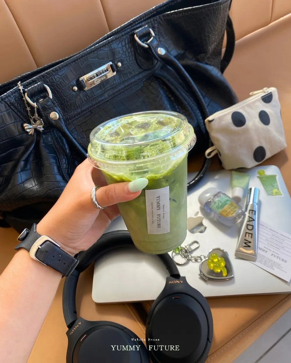 An iced matcha latte held over a desk